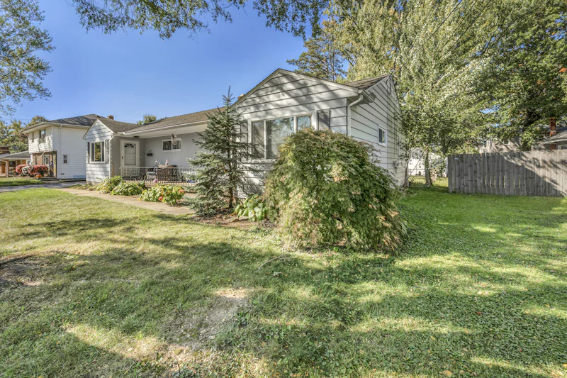 Light gray single-story house with a front porch on a suburban lot